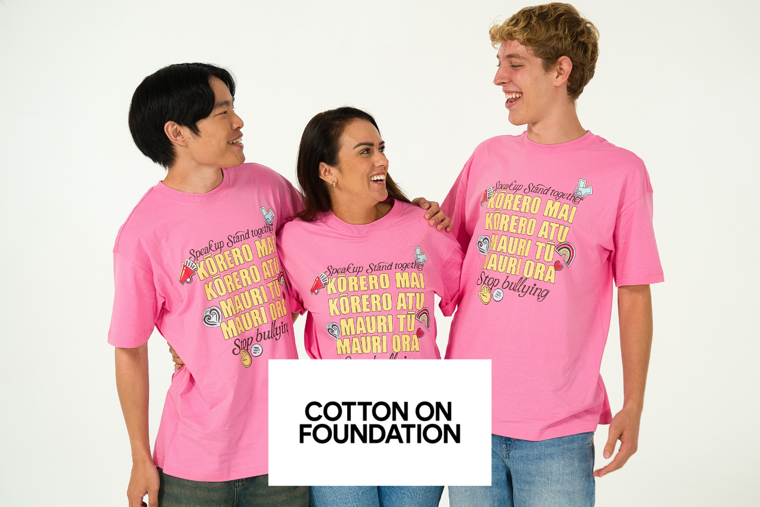 Three people in bright Pink Shirt Day T-shirts.