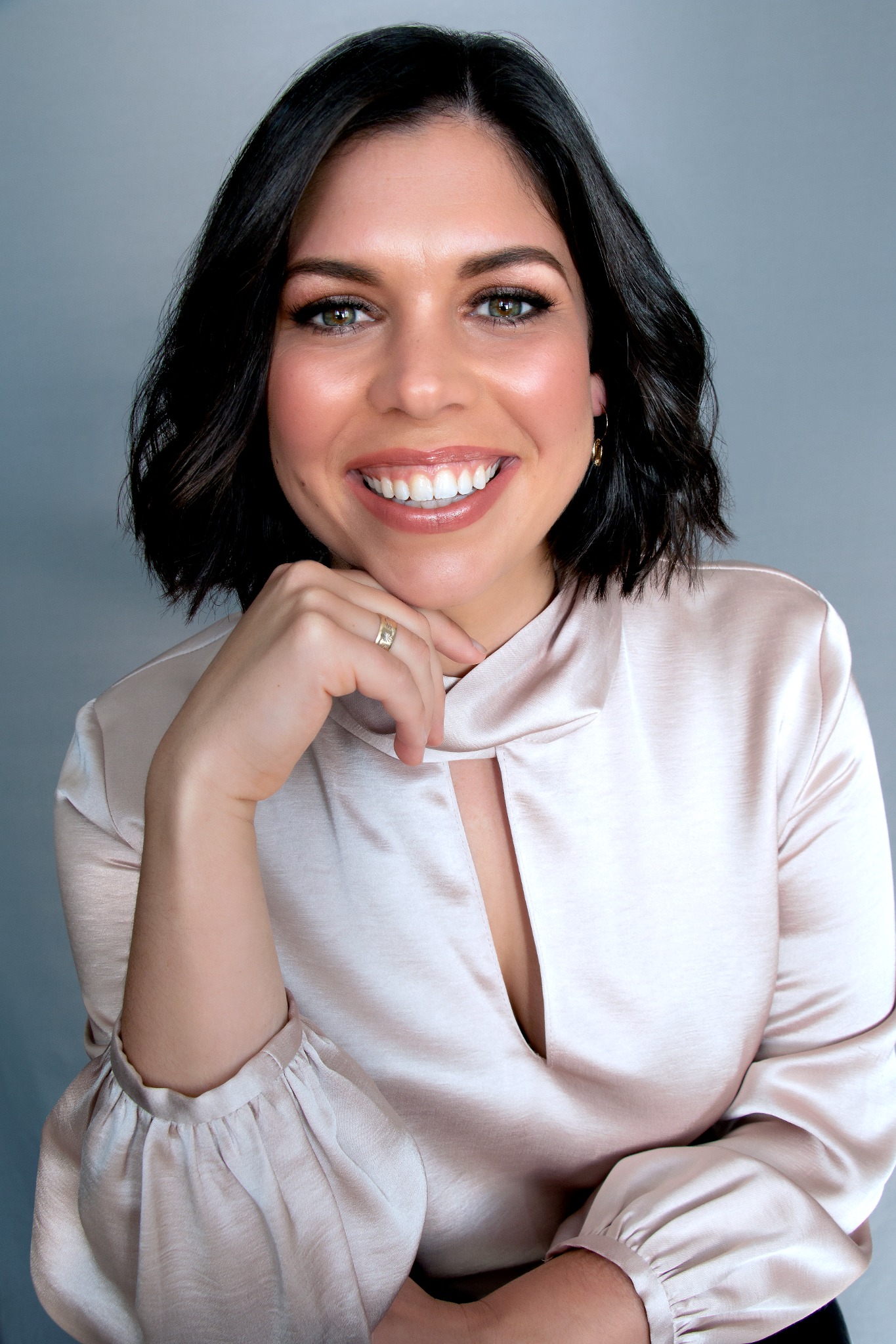 Professionally taken profile photo of a person smiling for the camera.
