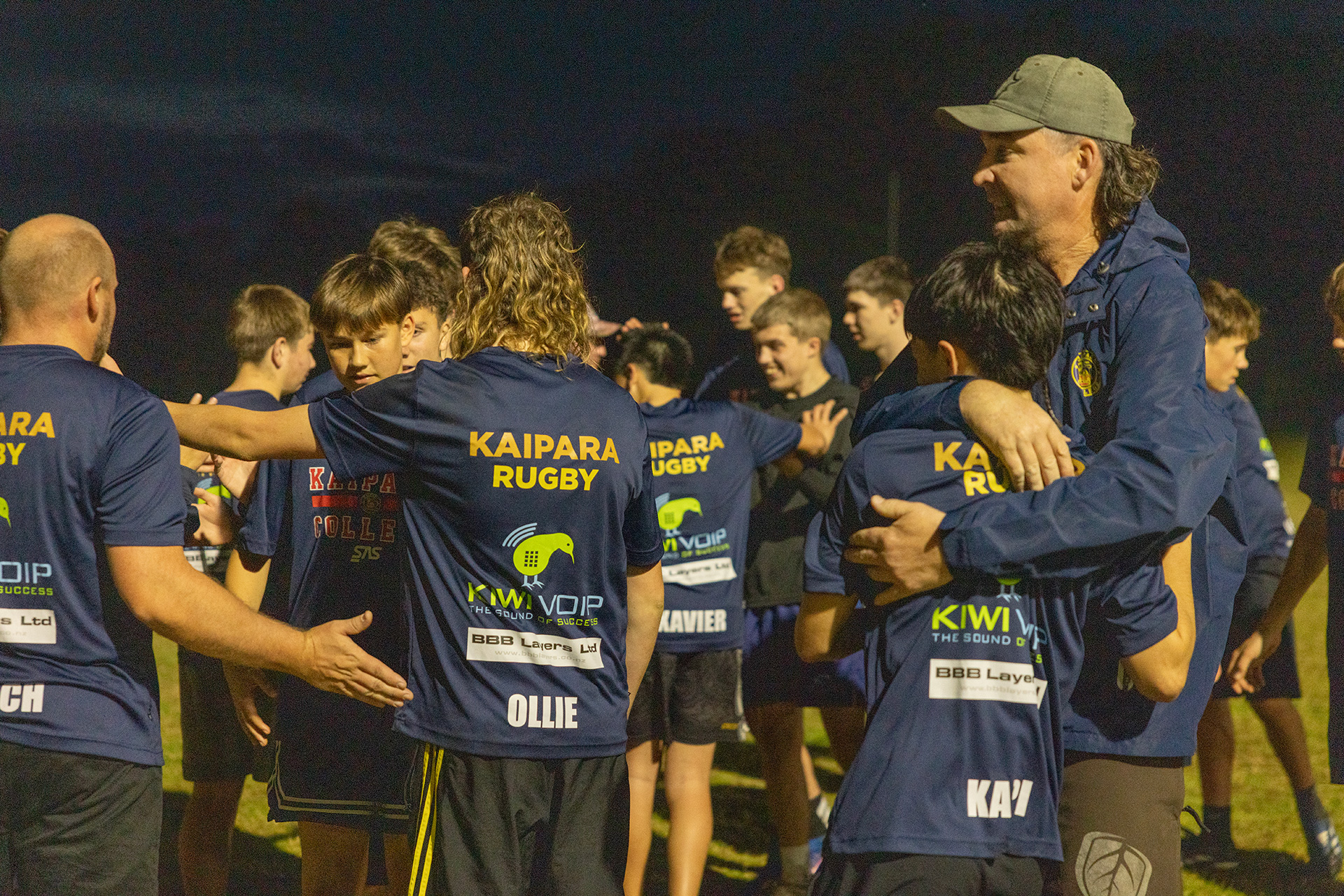 Group of youth rugby players and their coach.
